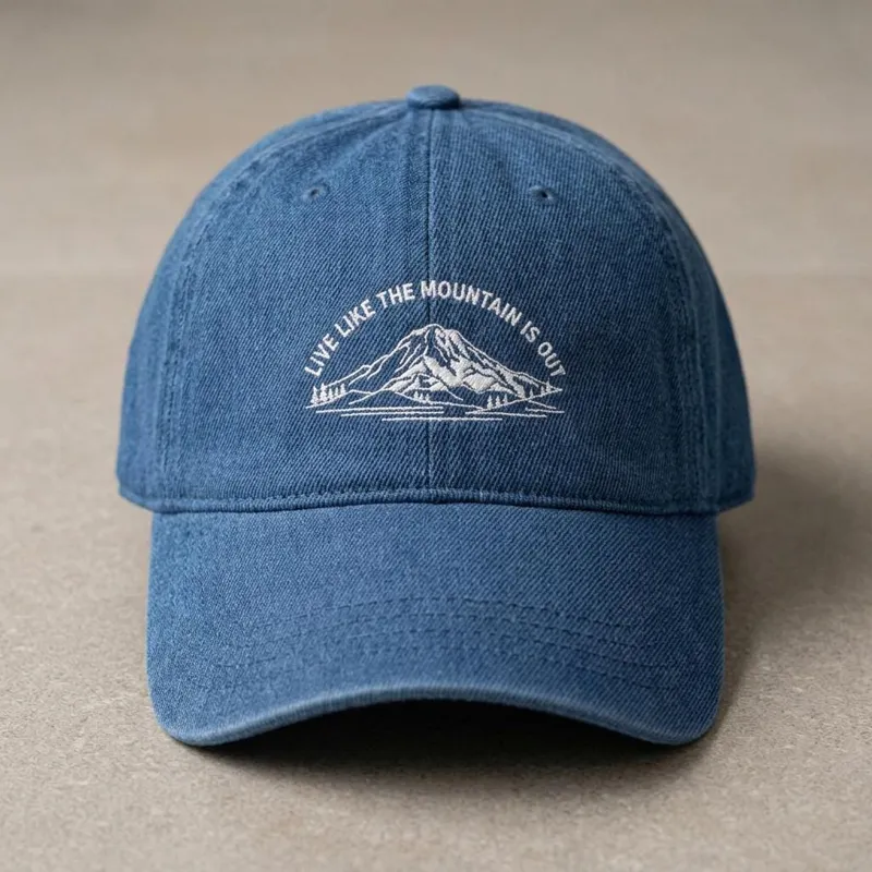 Embroidered denim baseball cap with Mount Rainier and Live Like the Mountain Is Out text